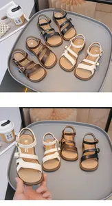 Detail view showing black, brown and white girls' summer sandals with buckle straps