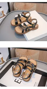 Detailed close-up of girls' black open-toe beach sandals featuring adjustable buckle straps