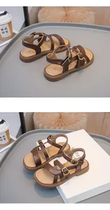 Close-up of stylish brown girls' sandals with gold buckles and beige insoles