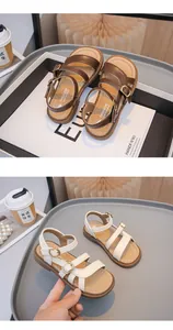 Details of stylish open-toe girls' sandals in brown and white faux leather