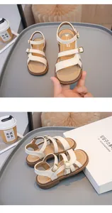Detail of off-white girls sandals with adjustable buckle straps and durable sole