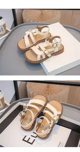 Detail view of cream girl's summer beach sandals with multi-strap buckle design.