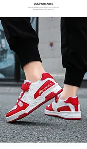 Detail view of red and white children's sneakers with ABC SHIELD logo and velcro