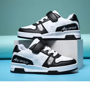 Detail of black and white children's leather sneakers with velcro straps