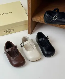 Close-up of retro French style girls Mary Jane shoes in brown, cream and black