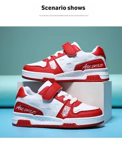 Red and white children's durable leather sneakers displayed on a white block for detail view