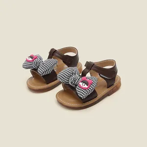 Toddler baby girl brown sandals with houndstooth bow and cute pink cartoon charm detail.