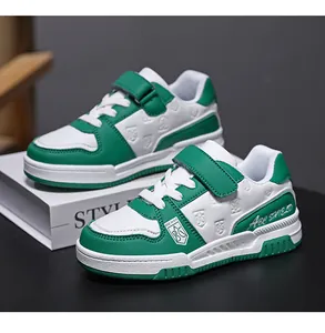 Detailed view of green and white children's sports shoes with hook and loop closure