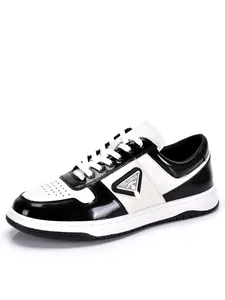 Side detail view of men's black and white leather low-top sneakers with lace-up design