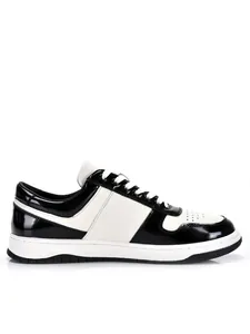 Professional side view of black and white leather low-top casual sneakers for men