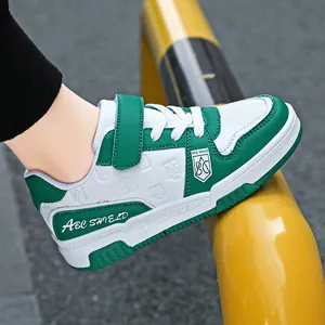 Vibrant green and white children's leather sneakers with velcro straps for boys and girls