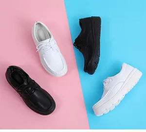 Close-up view of breathable white and black platform nurse shoes with lace-up design