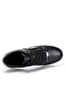 Professional top view detail of black genuine leather casual sneakers with lace-up design
