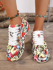 Close-up of women's graffiti print sneakers with platform sole and white laces