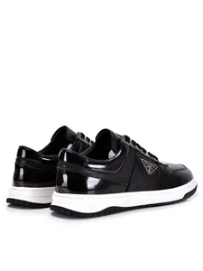 Rear view of sleek black leather low-top sneakers for men with side triangle logo design