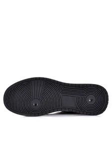 Detail view of the non-slip rubber sole pattern on a black men's casual board shoe.