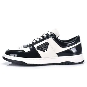 Classic black and white leather low-top men's sneakers featuring a stylish triangular logo
