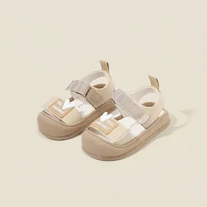 Fashionable beige closed-toe toddler sandals with cute heart detail and velcro strap