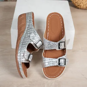 Detailed view of silver crocodile pattern wedge sandals with stylish double buckles
