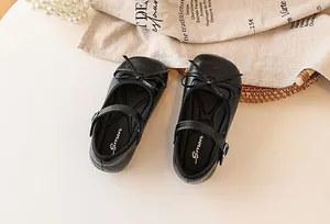 Elegant black girls Mary Jane shoes with bow decoration in a macro top view