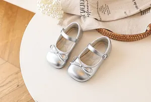 Detail view of silver toddler girl Mary Jane shoes featuring a stylish front bow