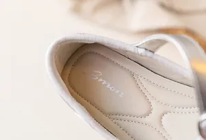 Close-up detail of the cushioned insole and stitching on girls' princess flat shoes.