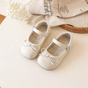Elegant beige girls' Mary Jane shoes with delicate bow detail for a spring princess look