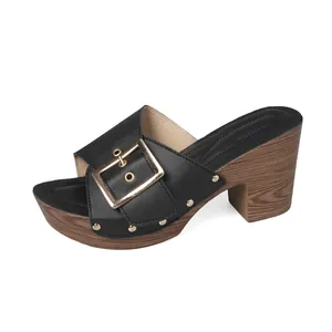 Elegant black platform slippers featuring a chunky wood-grain heel and large gold buckle