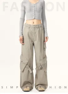 Detailed view of American vintage wide-leg cargo pants with large side pockets and straps.