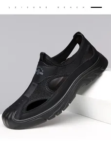 Close-up of black breathable mesh men's sandals with hollow design and soft sole.
