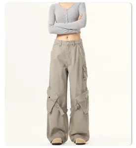 Full view of loose wide-leg cargo pants with large side pockets and strap details