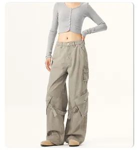 Detailed view of oversized cargo pants featuring multiple pockets and stylish strap accents.