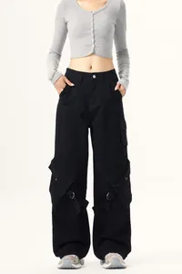 Full view of black wide-leg cargo pants with large side pockets and buckle strap details