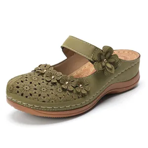 Vintage green hollow-out flower clogs for women with elegant floral appliqués and studs