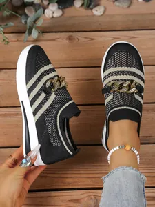 Detail view of women's striped mesh loafers with chunky gold chain and platform sole