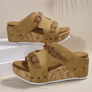 Detailed view of khaki platform wedge sandals with double buckle straps and cork sole