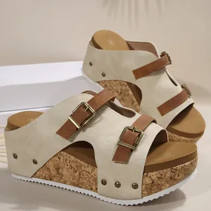 Detailed view of beige wedge sandals with cork platform and adjustable brown straps