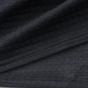 Close-up of black heavyweight jacquard checkered fabric showing fine stitching detail