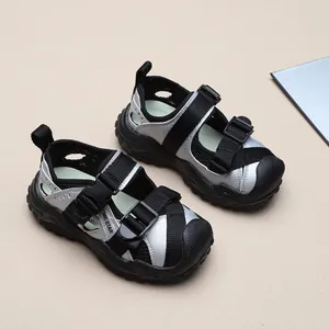 Detail view showing the mesh texture and buckle straps of boys' silver sports sandals