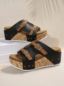 Detail view of women's wedge platform sandals with double adjustable buckles and cork texture