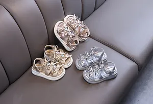 Stylish girls' princess sandals featuring rhinestone bow accents in metallic gold and silver