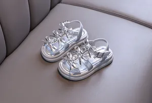 Elegant silver girls princess sandals with sparkly rhinestones and butterfly bow details.