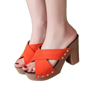 Vibrant orange suede cross-strap high heeled mules with silver rivets and block heels