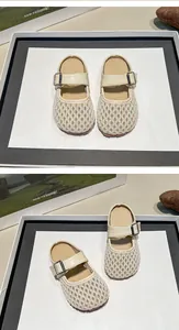 Detailed view of cream mesh children's mules with breathable hollow design and buckle strap.