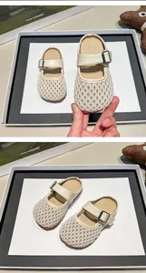 Close-up detail of children's breathable mesh mule slippers with buckle strap