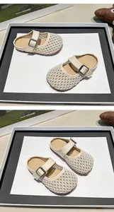 Detailed view of breathable mesh children's clogs with adjustable buckle strap
