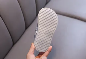 Macro view of non-slip rubber sole with size 26 engraving on girl's princess sandal