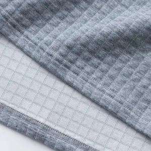 Detailed macro view showing the grey heavy jacquard fabric texture and hemline finish