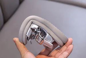 Close-up of flexible silver girl's sandals showing soft rubber sole bending detail