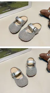 Detailed view of girls' breathable silver mesh hollow-out flat mules with metal buckle